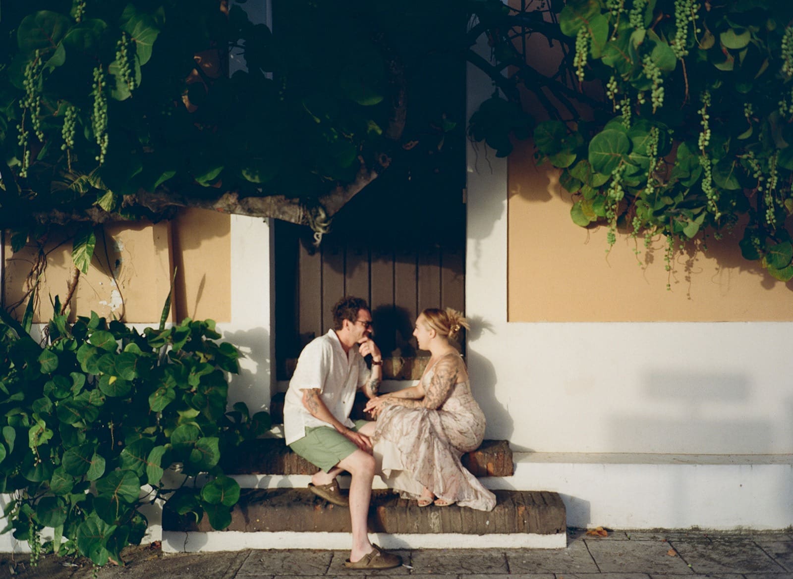 natural wedding photo of a bride and groom sharing an intimate moment chatting on the stairs