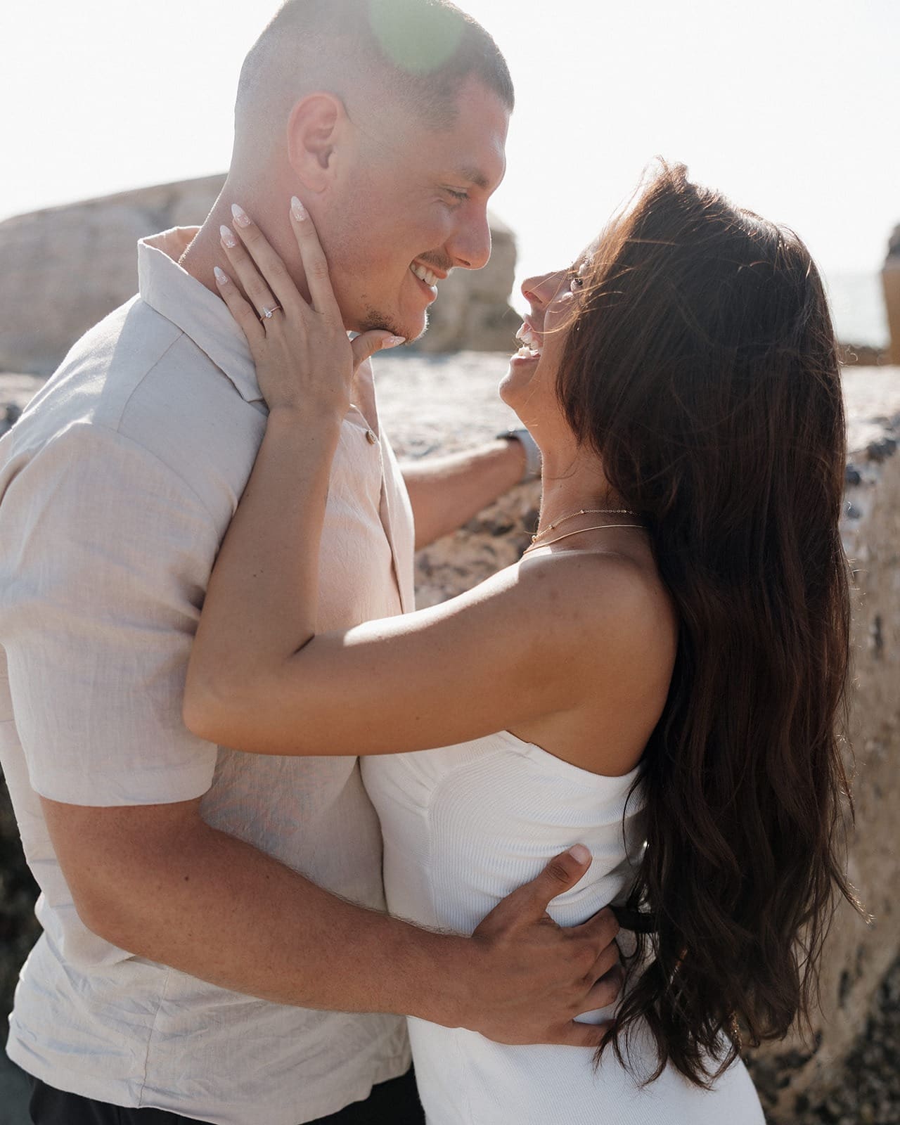 bride and groom smiling at each other, a perfect examples of how to smile naturally for wedding photos