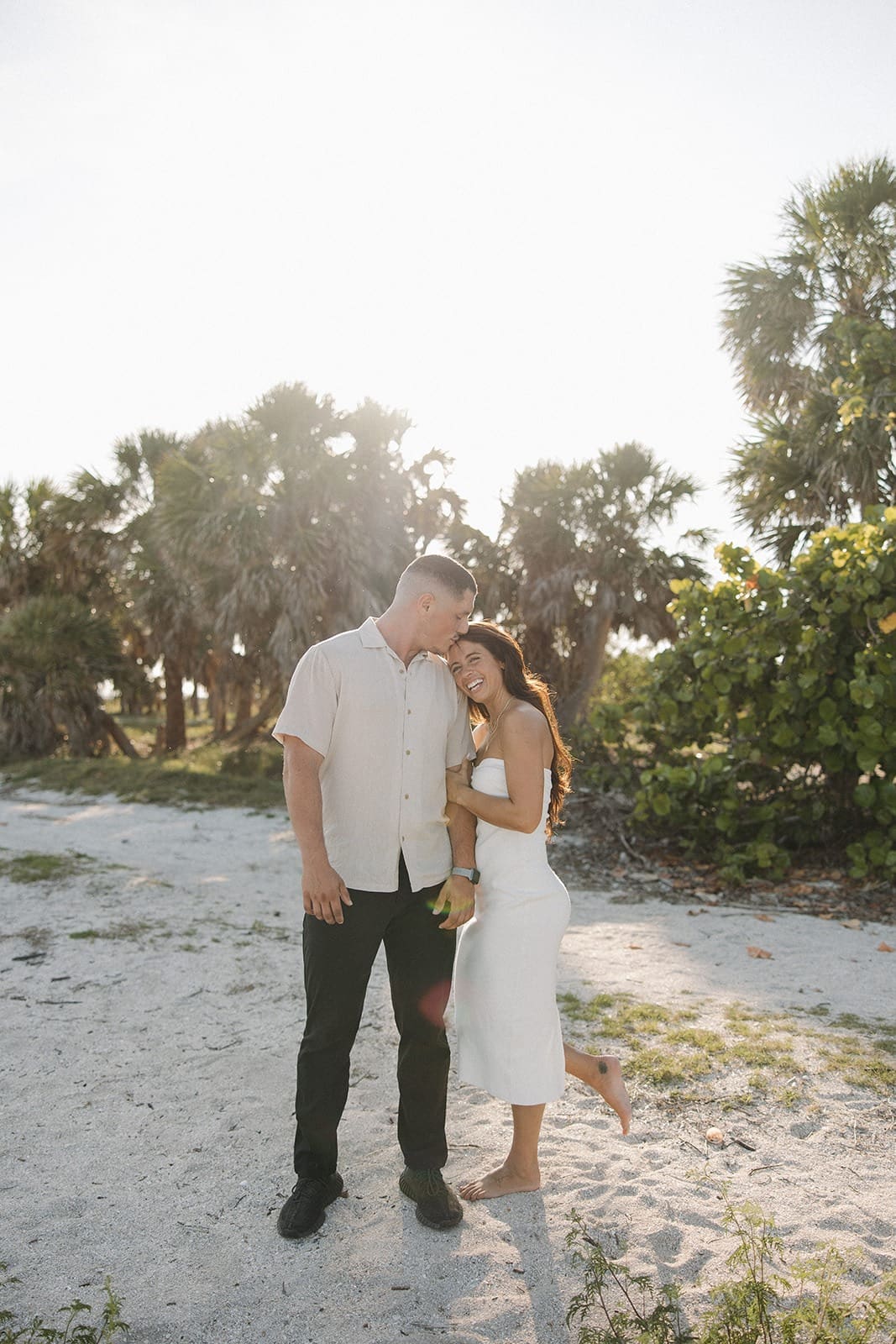 natural wedding photo of a bride leaning on her groom's shoulder during their portrait session