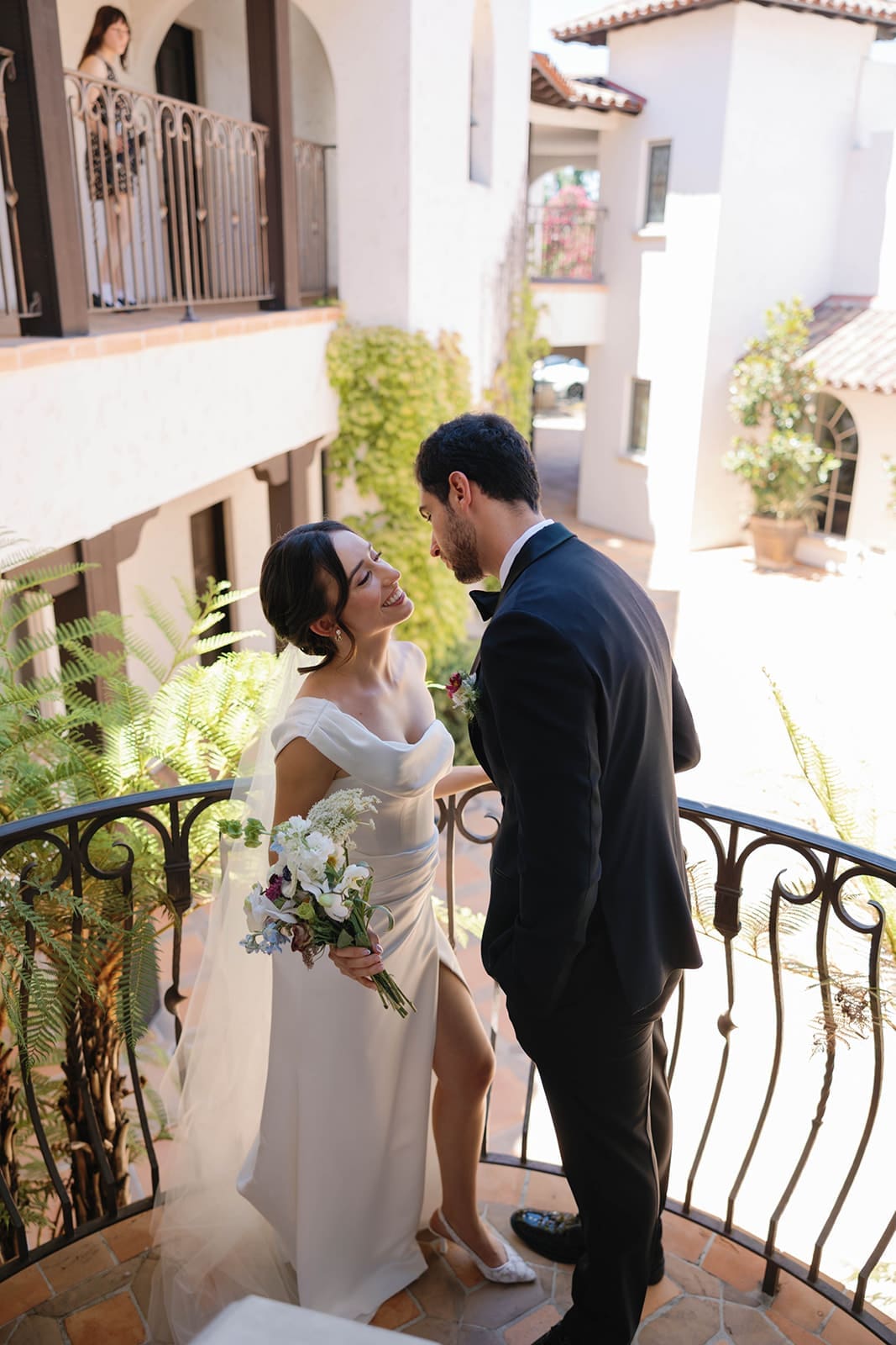 candid photo of a bride and groom smiling at each other, showing how to feel natural in wedding photos