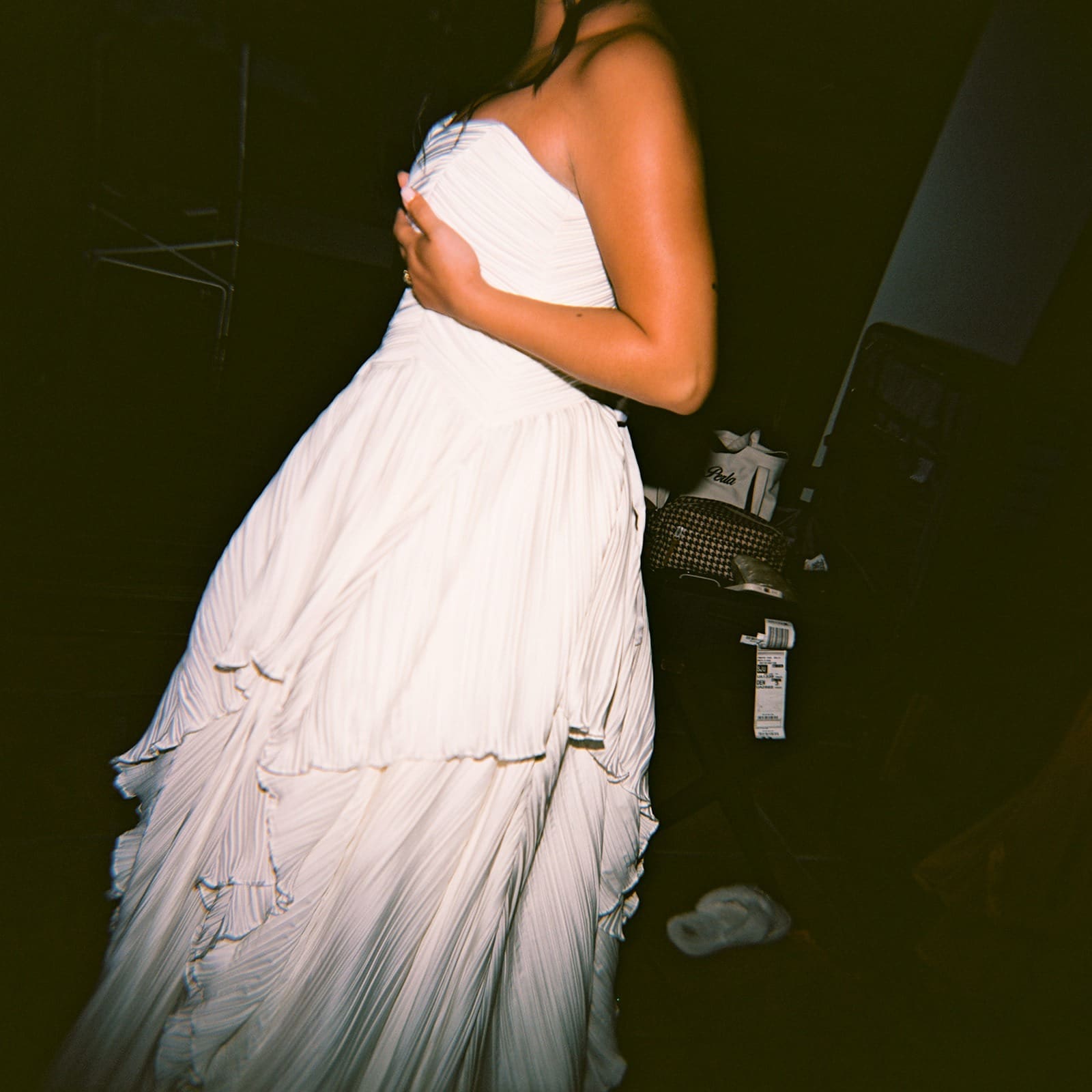 film portrait of a bride holding her wedding dress up while she's getting ready to get married at the most beautiful wedding venue in rincon