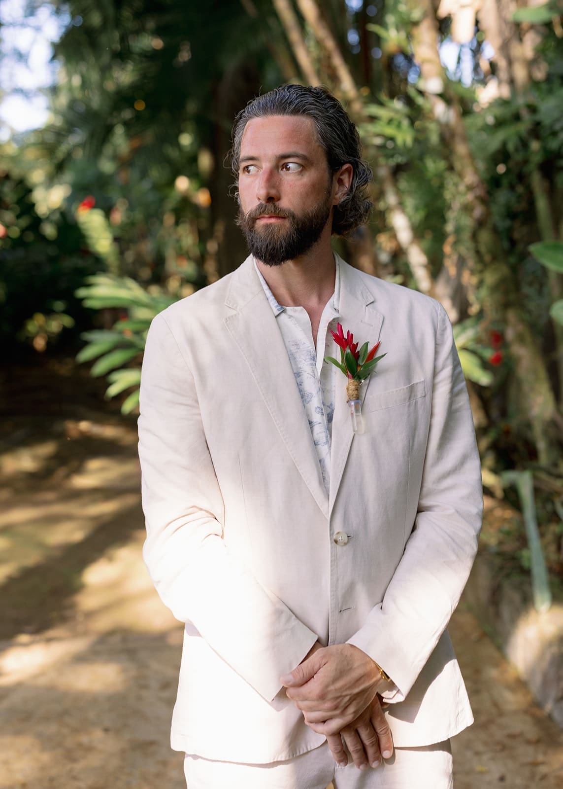 portrait of a groom standing in the garden of his Rincón wedding venue