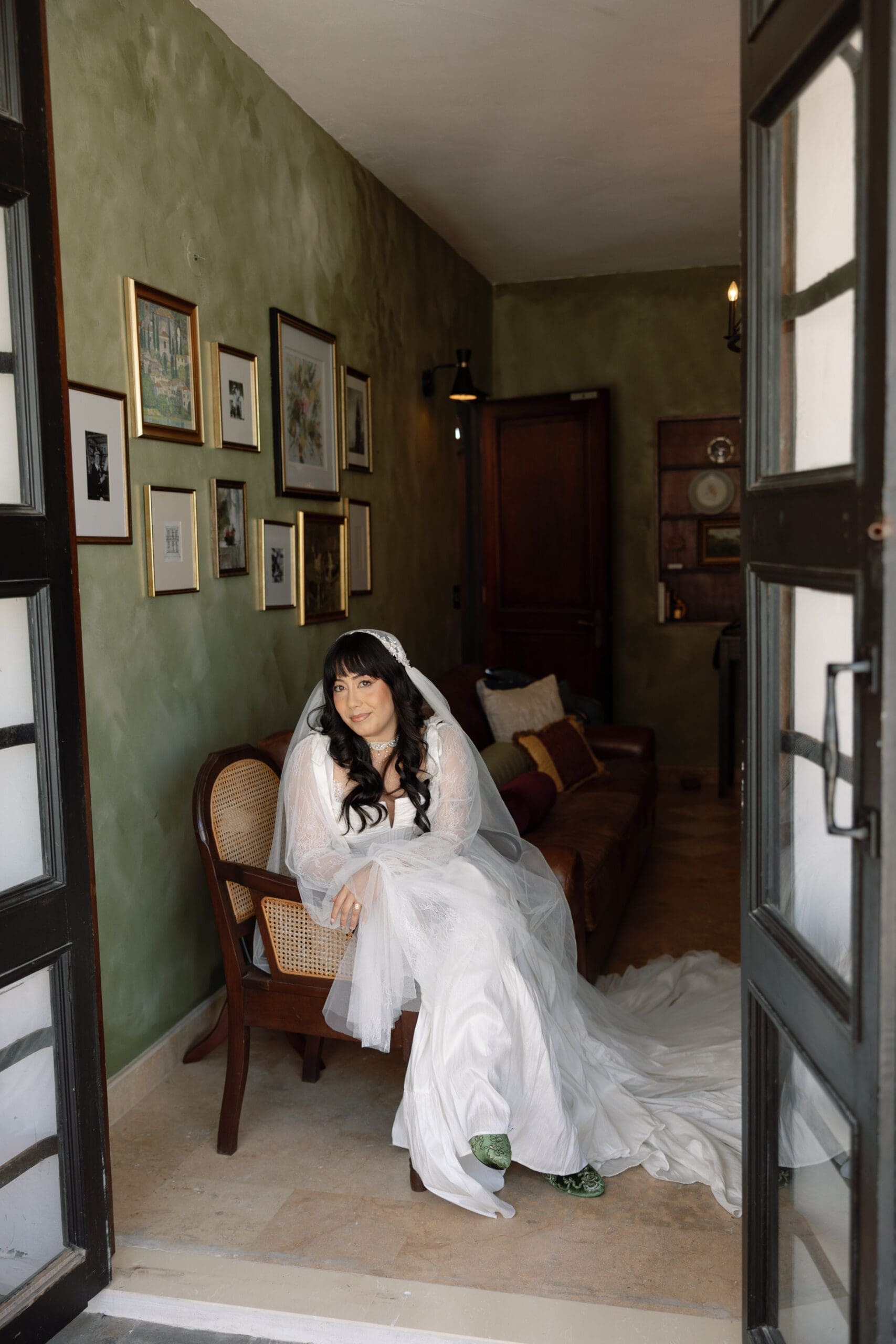 Bride seated indoors in her wedding dress before her San Juan wedding