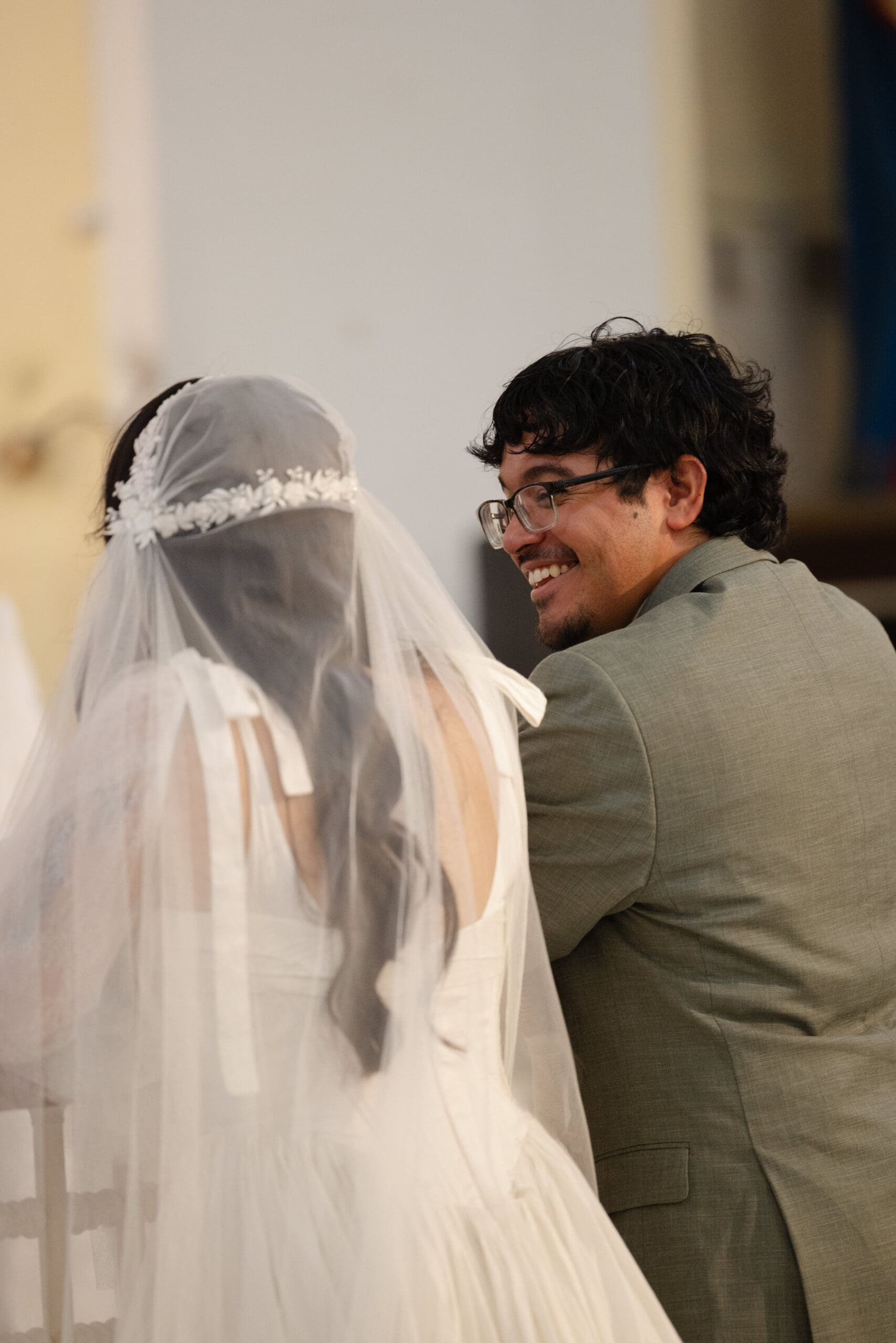 Groom smiling at his bride during their church wedding ceremony in San Juan, Puerto Rico