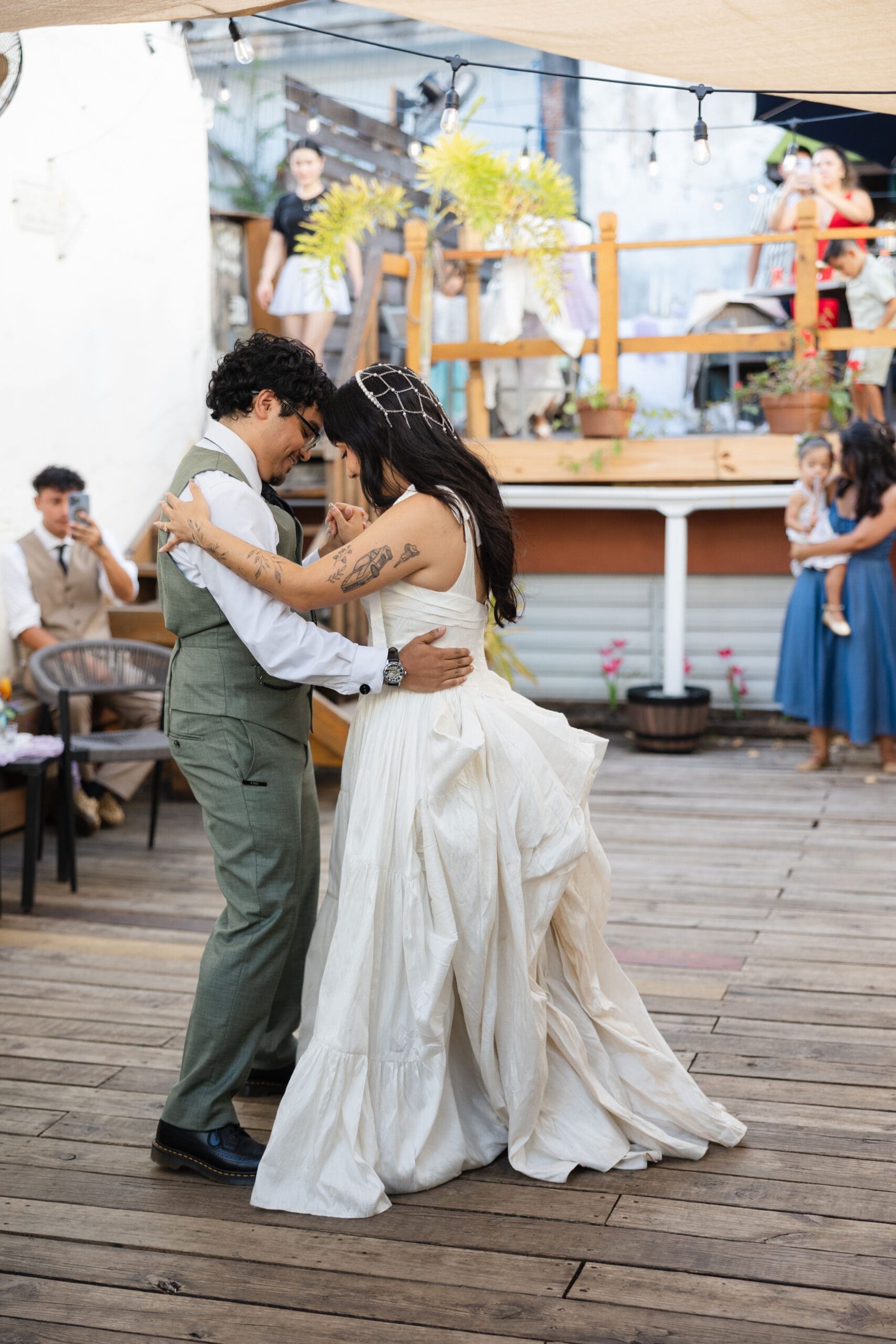 Newlyweds dancing together during their outdoor wedding reception in San Juan