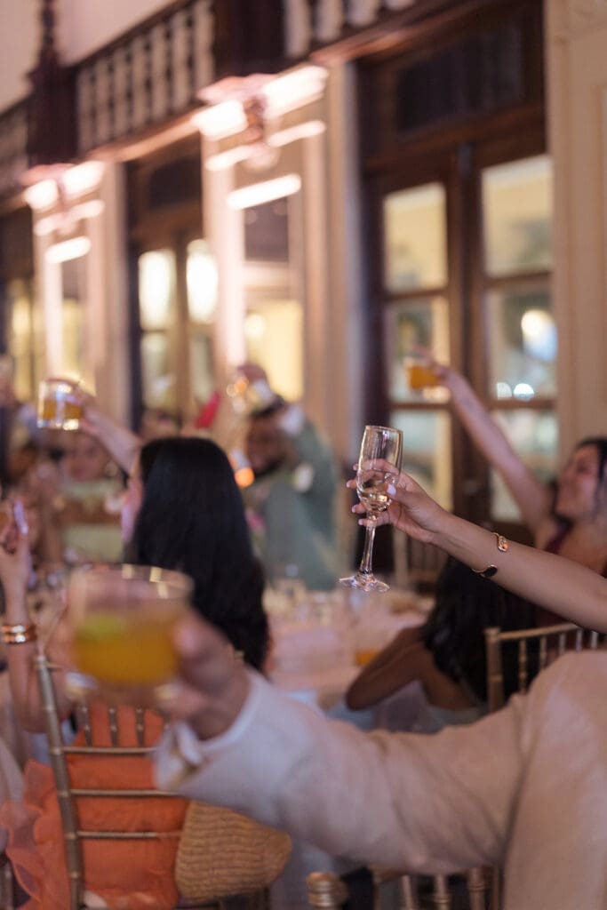 Wedding guests raising their glasses for a toast during the Casa de España reception.